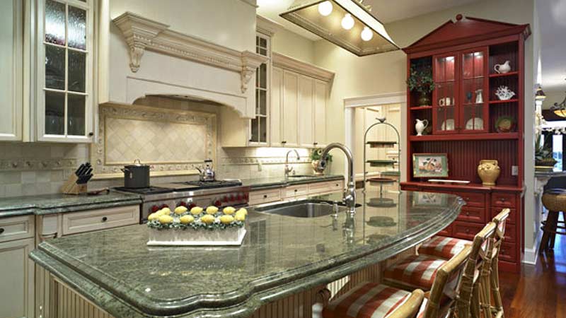 Residential kitchen with custom cabinetry and marble countertops